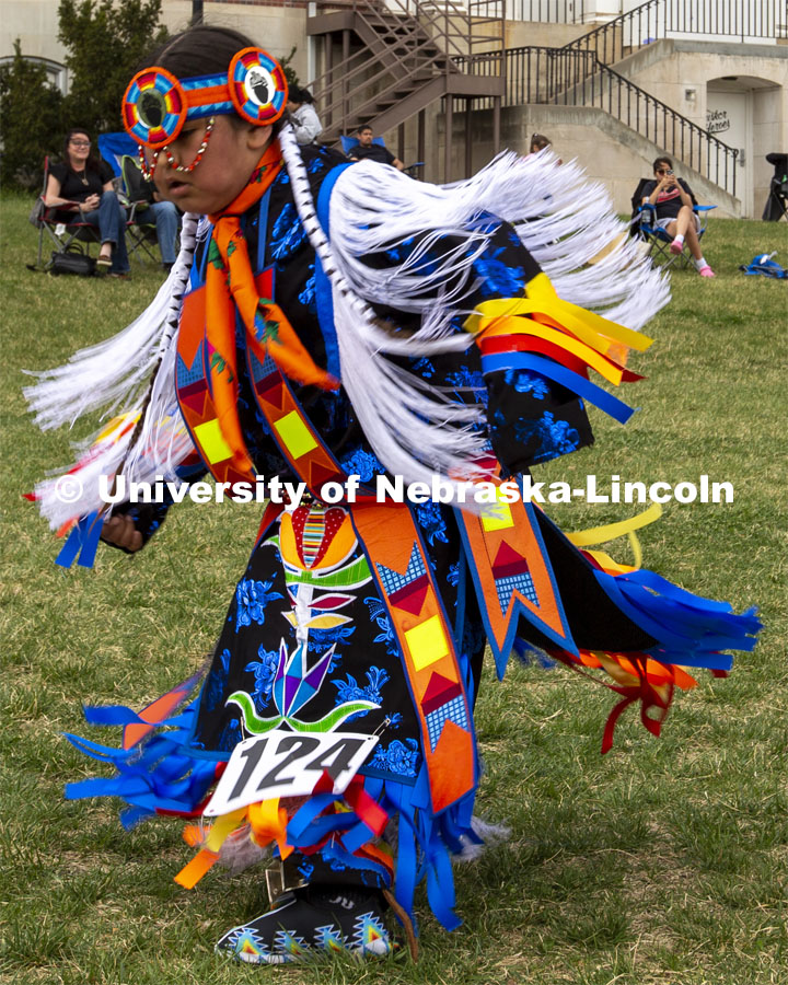 A young dancer competes for prizes during the 2022 UNITE powwow. 2022 UNITE powwow to honor graduates (K through college). Held April 23 on the greenspace along 17th Street, immediately west of the Willa Cather Dining Center. This was UNITE’s first powwow in three years. The MC was Craig Cleveland Jr. Arena director was Mike Wolfe Sr. Host Northern Drum was Standing Horse. Host Southern Drum was Omaha White Tail. Head Woman Dancer was Kaira Wolfe. Head Man Dancer was Scott Aldrich. Special contest was a Potato Dance. April 23, 2023. Photo by Troy Fedderson / University Communication.